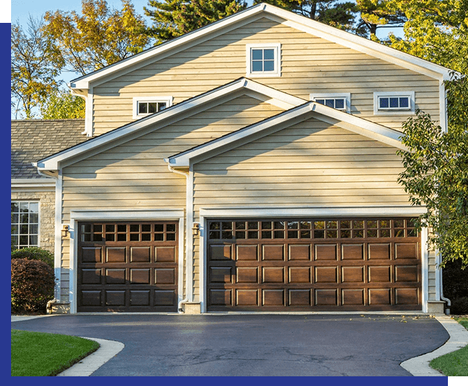 A large garage with two doors and a driveway.